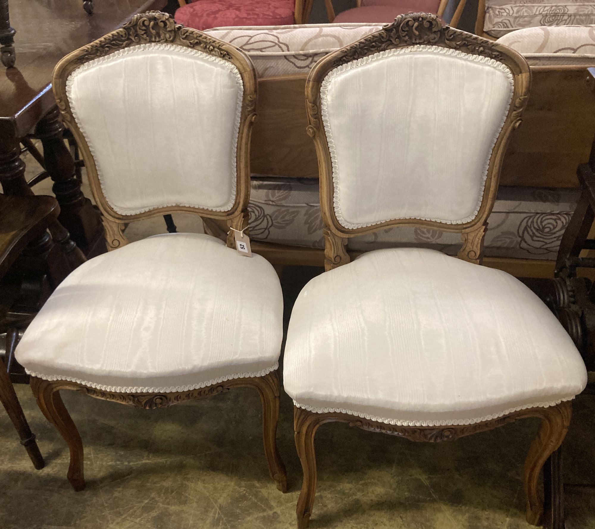 A pair of Louis XV style carved walnut side chairs